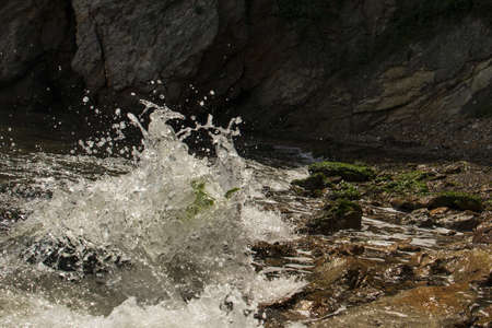 water splashes over rocks