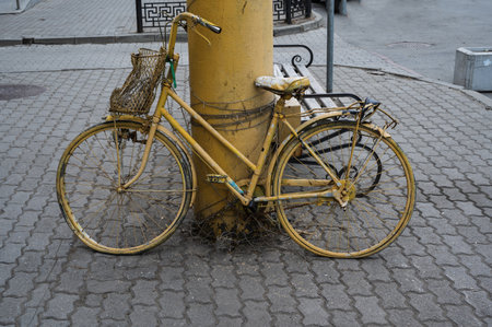 Old yellow bicycle on the cobblestone street in Vladivostok Russiaの写真素材