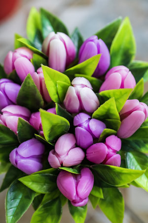 Bouquet of pink and purple tulips on a wooden backgroundの写真素材