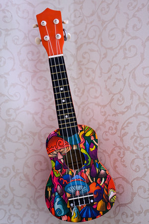 Ukulele with colorful patterns on a background of the wall.の写真素材