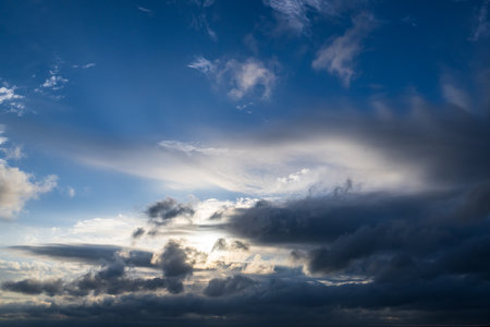 Cloudscape, Colored Clouds at Sunset near the Ocean with a blue Skyの写真素材
