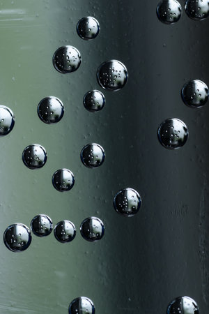 Water drops on a metal surface. Abstract background and texture for design.
