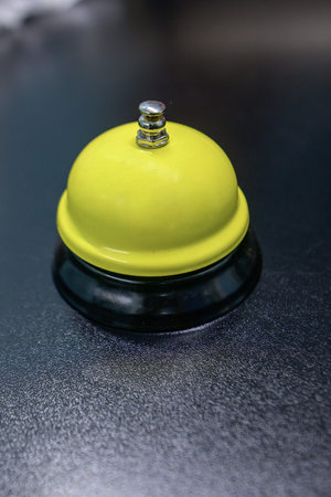 yellow table bell on a black background
