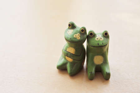 A couple of carved wooden frogsの写真素材