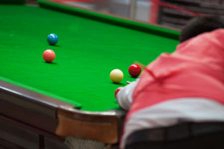 A man plays snooker does hit the fuzzy balls from the back