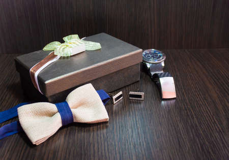 Genuine accessories as a gift to the man on brown backgroundの写真素材