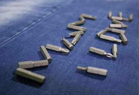 The inscription on the mother on a blue background jeans lined with metal set for screwdriversの写真素材