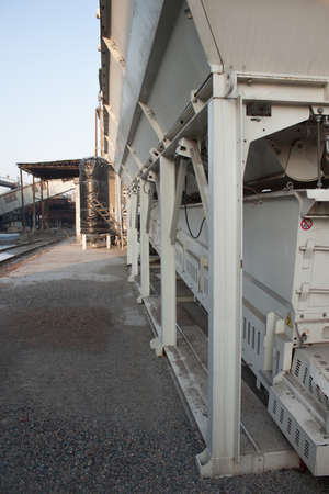 Small concrete batching plant with silo at sunrise
