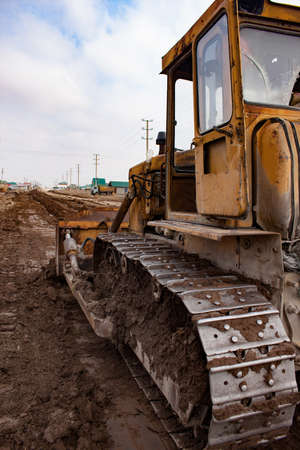 Bulldozer at work on construction site moves soilの写真素材