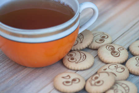 Cool cookies with smiles and tea. a little blur