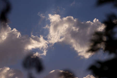 Clouds on the blue sky background, with hints of sunset on vacation