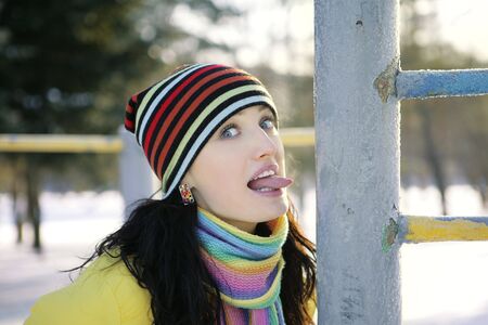 Girl in winter in the park language iron pipeの写真素材