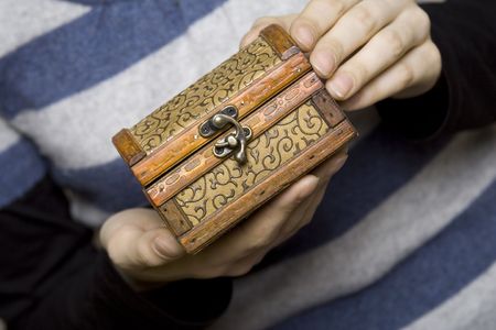 Hands holding a decorative wooden boxの写真素材