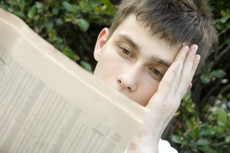 Young man Reading Newspaperの写真素材