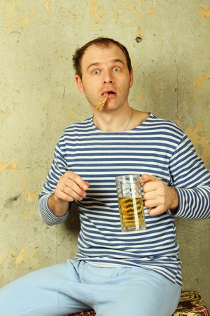 Closeup of a man with a glass of beerの写真素材