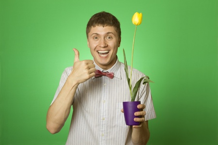 Man holding a tulip grown in a potの写真素材