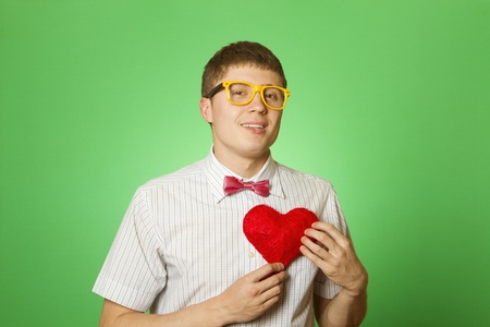 Smiling guy holding heart shapeの写真素材