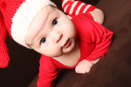 Close-up of a small child in a red knitted capの写真素材