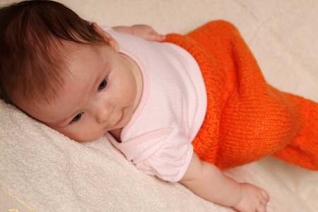 Close-up of a little girl lying on her backの写真素材