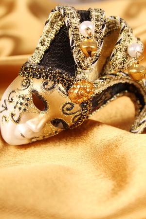 Carnival mask lying on a yellow silkの写真素材