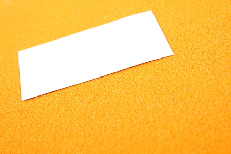 A white sheet of paper lying on the yellow sand  Backgroundの写真素材