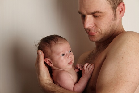Close-up of a caring father with a baby in her arms.の写真素材