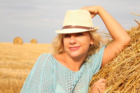 Close-up of young Beautiful woman near haystackの写真素材