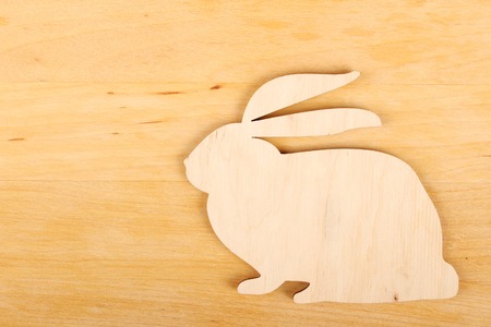 Wooden silhouette of the rabbit  On a wooden backgroundの写真素材