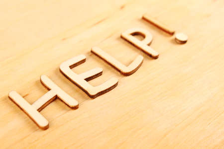 Closeup on wooden wooden letters  Help  