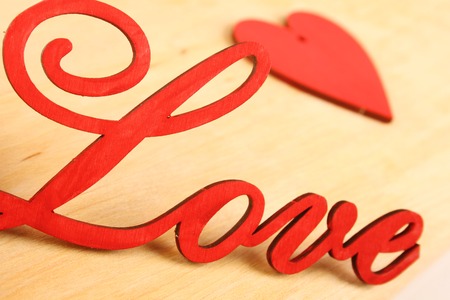 Love wooden letters on the background of the little red heartsの写真素材