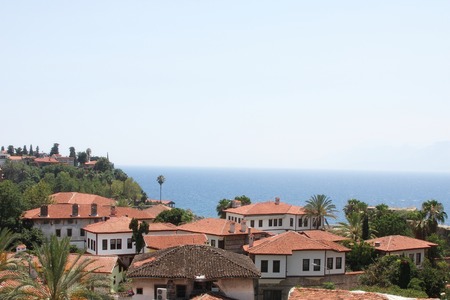 Red roofs of the city on the sea and the skyの写真素材