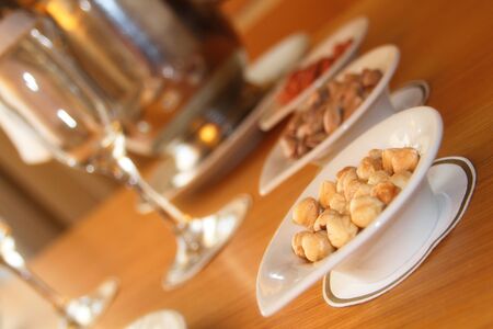 Tableware, glasses, champagne, and a lot of different nutsの写真素材
