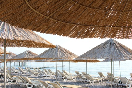 Rocky Beach with sun beds and umbrellasの写真素材