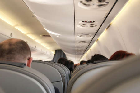 Airplane with passengers of economy class cabinの写真素材