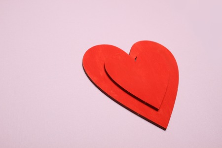 Background of small red hearts scattered on the yellow backgroundの写真素材
