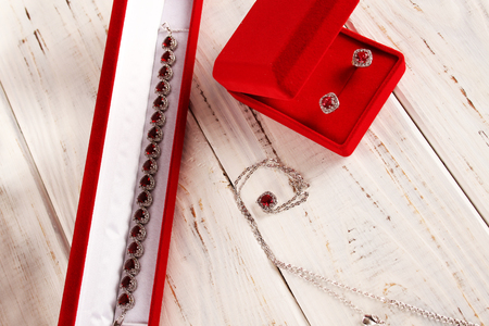 Precious jewelery in white gold with rubies. Necklace, earrings and chain with pendant.の写真素材