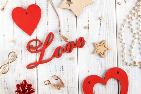 Flatlay for a declaration of love. White boards with red hearts, text love, gifts and treasure.の写真素材