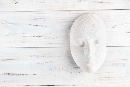 The towel hangs in the bathroom on a heated towel rail, all in shades of brownの写真素材