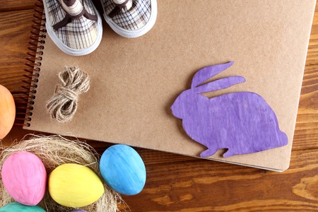 Easter bunny and colored eggs. Wooden lilouet. Background