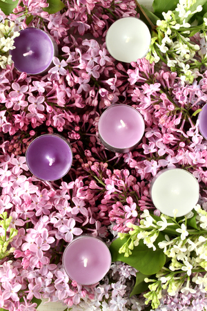 Spa therapy purple and white candles and lilacの写真素材