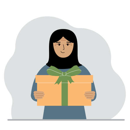 Happy muslim woman holds a large gift box with a bow in his hands. Vector flat illustrationのイラスト素材