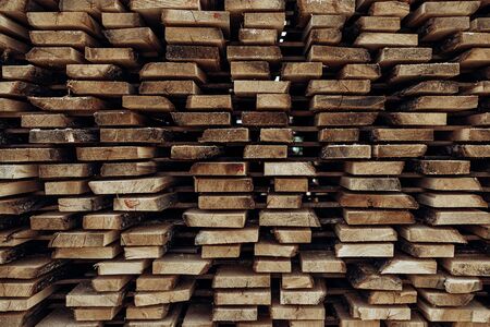 Piles of wooden boards in the sawmill, planking.