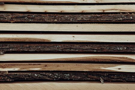 Piles of wooden boards in the sawmill, planking.の写真素材