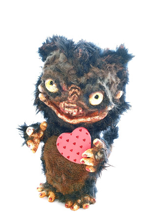 Teddy Monster on a white background with two hearts in paws toy for interior courtesy beastの写真素材