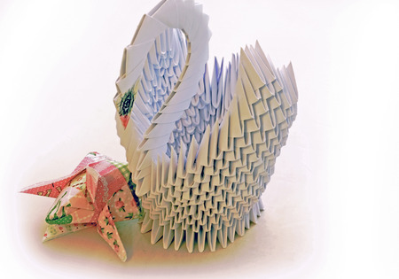 Swan made of paper for the interior, with folded napkins in the form of tulip flowersの写真素材