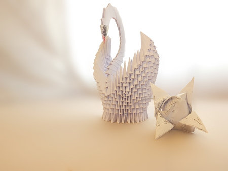 Swan made of paper for the interior, with folded napkins in the form of tulip flowers, White backgroundの写真素材