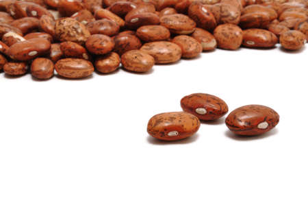 Three Pinto  Mottled  Beans Isolated On White With Many More In the Background