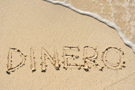 Dinero  Money  Written in the Sand on a Beachの写真素材