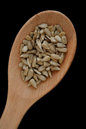 Hulled Sunflower Seed Kernels on Wooden Spoonの写真素材