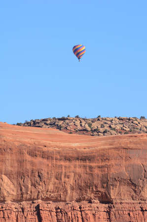 Hot Air Balloon Above Sandstone Mesa Near Moab, Utahの写真素材